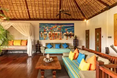 a living room with a couch and a table at Hazel Azalea 4 BR Private Pool Villa in Seminyak