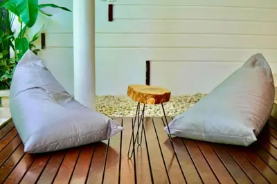 two pillows on a wooden deck with a table at Luxury 2 BR Private Pool Villa ZN101 in Seminyak