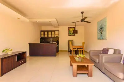 a living room with a couch and a table at Lavender 1 BR Private Pool Villa in Seminyak