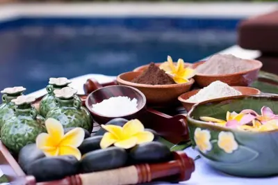 a table topped with vases and bowls of food at Ageratum 4 BR Villa Private Pool in Seminyak