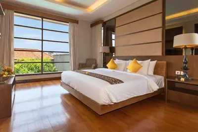 a bedroom with a large bed and a large window at Luxury 3 BR Private Pool Villa in Seminyak