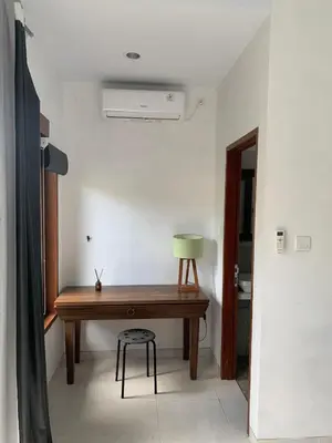 a room with a wooden desk and a chair at Jimbaran Beauteous Villa in Jimbaran