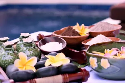 a table topped with bowls and plates of food at Dahlia Mentari 2 BR Private Pool Villa in Seminyak