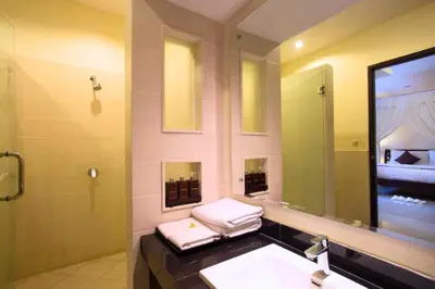 a bathroom with a sink and a mirror at Allamanda 3 BR Private Pool Villa in Seminyak