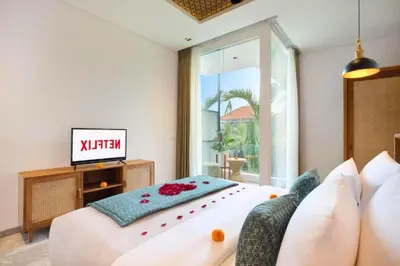 a bedroom with a bed and a tv in it at Modern 3 BR Private Pool Villa in Legian