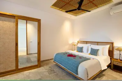 a bedroom with a large bed and a mirror at Modern 3 BR Private Pool Villa in Legian