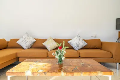 a living room with a couch and a coffee table at Villa Ayuni, Berawa in Canggu