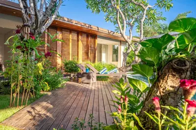 a wooden walkway leading to a house at Villa Ayuni, Berawa in Canggu