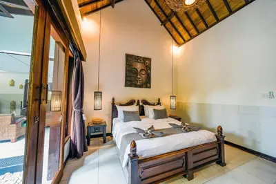 a bedroom with a bed in a room at Villa JES - 4 Bedroom Villa - Legian in Legian