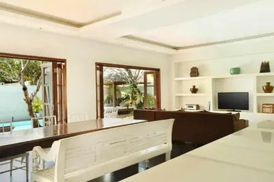 a living room with a table and a couch at Cozy 2 BR Private Pool Villa in Seminyak