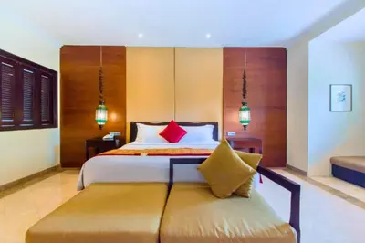 a bedroom with a bed and a bench with red pillows at Entire 2 BR Private Pool Villa in Seminyak