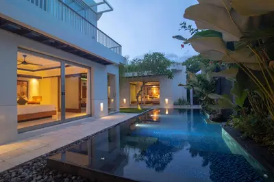 an external view of a villa with a swimming pool at Rekso Villa in Jimbaran