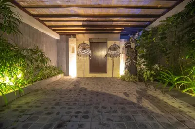 a walkway leading to a door in a building at Rekso Villa in Jimbaran