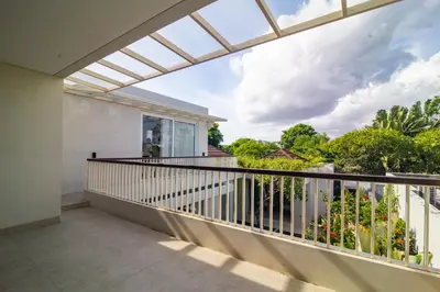 a balcony with a view of the garden at Rekso Villa in Jimbaran