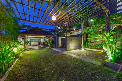 an indoor garden with a pergola and plants at Entire 3 BR Private Pool Villa in Seminyak