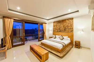 a bedroom with a large bed and a balcony at Entire 3 BR Private Pool Villa in Seminyak