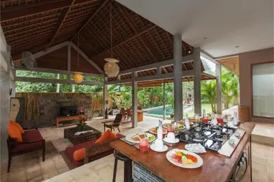 a kitchen and living room with a stove in a house at Clover 3 BR Private Pool Villa in Canggu