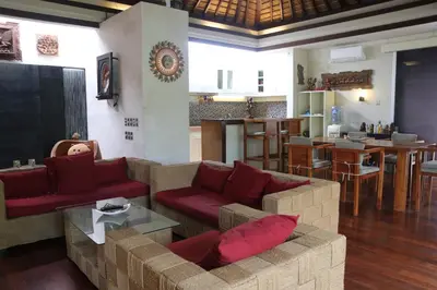 a living room with a couch and red pillows at Vlad Bali Villa in Jimbaran