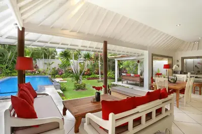 a living room with a table and chairs and a pool at Villa Viona 4 in Seminyak