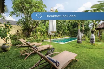 a villa with a garden with a swimming pool at Villa Kuda Sumba by BaliSuperHost in Kerobokan