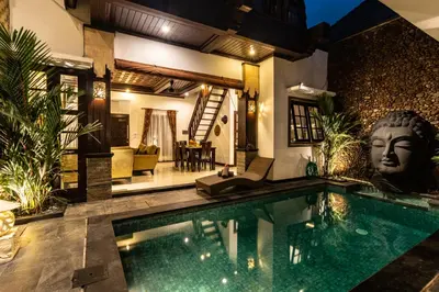 a villa with a swimming pool and a house at PROMO Uniquely Styled Spacious 3bd Villa in Kerobokan
