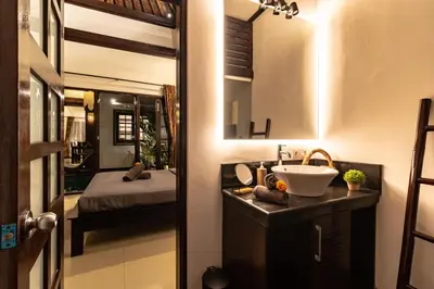 a bathroom with a sink and a bed in a room at PROMO Uniquely Styled Spacious 3bd Villa in Kerobokan