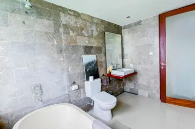 a bathroom with a toilet and a sink at Spacious 2 BR Private Pool Villa ZN108 in Seminyak
