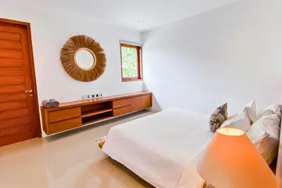 a bedroom with a bed and a mirror on the wall at Spacious 2 BR Private Pool Villa ZN108 in Seminyak