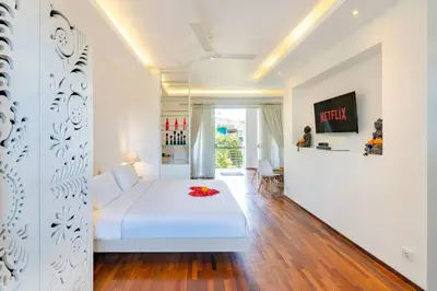 a bedroom with a white bed in a room at Cosy 1 Bd Pvt Apartment with shared kitchen and pool in Seminyak