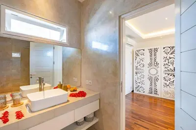 a bathroom with a sink and a mirror at Cosy 1 Bd Pvt Apartment with shared kitchen and pool in Seminyak