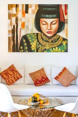 a painting of a woman sitting on a couch at Cosy 1 Bd Pvt Apartment with shared kitchen and pool in Seminyak