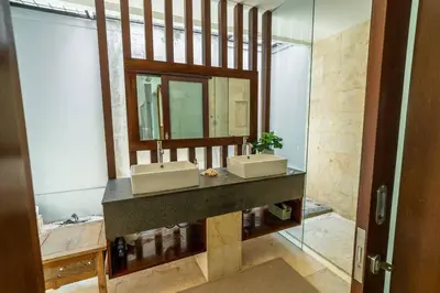 a bathroom with two sinks and a mirror at Ocean Breeze Villa -4BR villa in Canggu in Canggu