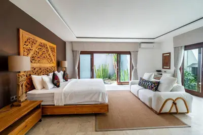 a large bedroom with a large bed and a couch at Ocean Breeze Villa -4BR villa in Canggu in Canggu