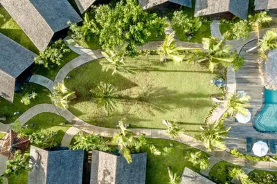 an overhead view of a park with palm trees and a road at One BR Bungalow Cozy Place in Canggu