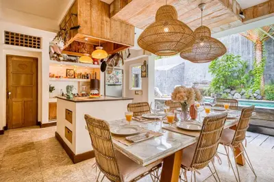 a kitchen and dining room with a table and chairs at New Listing 1 BD Vintage Charm in Central Berawa in Canggu