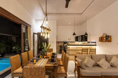 a living room with a table and a couch at Comfy 3bd Family Villa with Private Pool in Central Location in Kerobokan