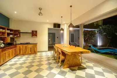 a large kitchen with a wooden table in a room at Stylish 1 Bd Pvt Apartment w shared kitchen and pool in Seminyak