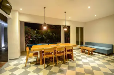 a dining room with a table and chairs and a couch at Stylish 1 Bd Pvt Apartment w shared kitchen and pool in Seminyak