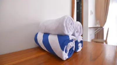 a pile of towels sitting on top of a wooden floor at Queen Villa Seminyak in Seminyak