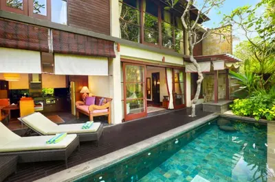 a villa with a swimming pool and a house at Ari Ayra 1 BR Private Pool Villa in Jimbaran