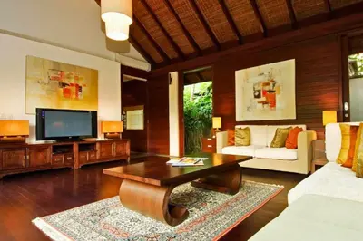 a living room with a couch and a tv at Ari Ayra 1 BR Private Pool Villa in Jimbaran