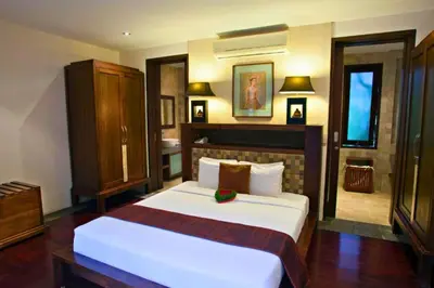 a bedroom with a large white bed in a room at Dean 2 BR Private Pool Villa in Jimbaran