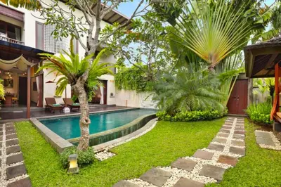 a backyard with a swimming pool and a house at Dean 2 BR Private Pool Villa in Jimbaran