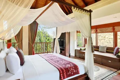 a bedroom with a bed and a balcony at Azarina 3 BR Private Pool Villa in Jimbaran