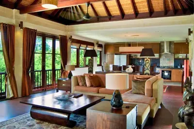a living room with a couch and a table at Azarina 3 BR Private Pool Villa in Jimbaran