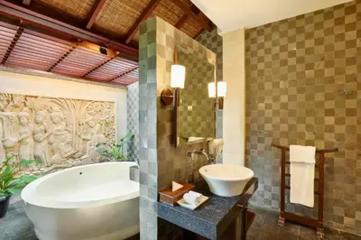 a bathroom with a tub and a sink at Azarina 3 BR Private Pool Villa in Jimbaran