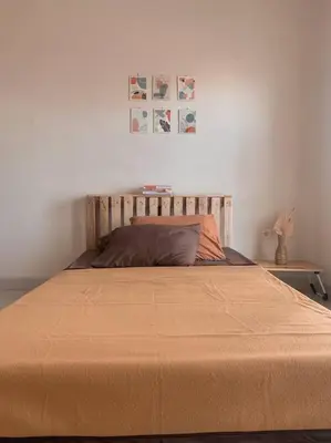 a bedroom with a large bed with a blanket on it at Conscious House near Kuta and Seminyak in Legian