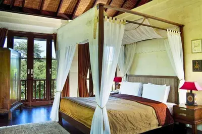 a bedroom with a bed with a canopy at Dendalion 4 BR Private Pool Villa in Jimbaran