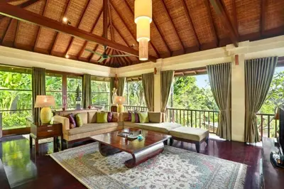 a living room with a couch and a table at Dendalion 4 BR Private Pool Villa in Jimbaran