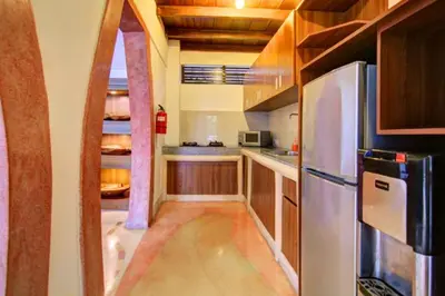 a kitchen with wooden cabinets and a stainless steel refrigerator at Cozy Executive 2 BR Pool Villa in Seminyak